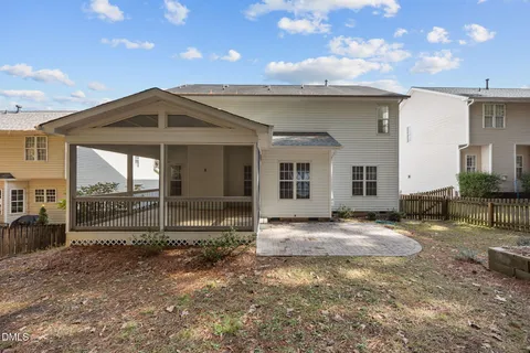 a yellow house with trees in front of it