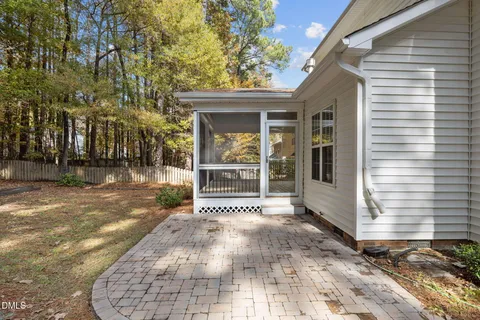 a front view of a house with a yard and tree s