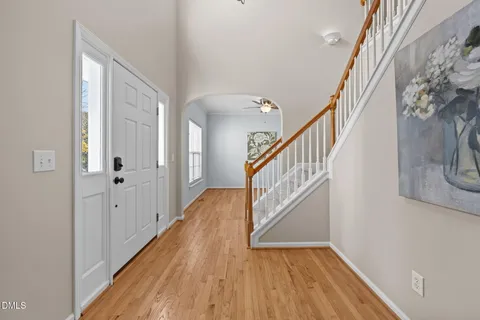 a view of a hallway with wooden floor and staircase