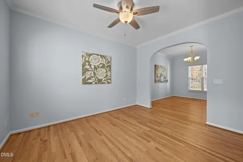 a view of empty room with wooden floor