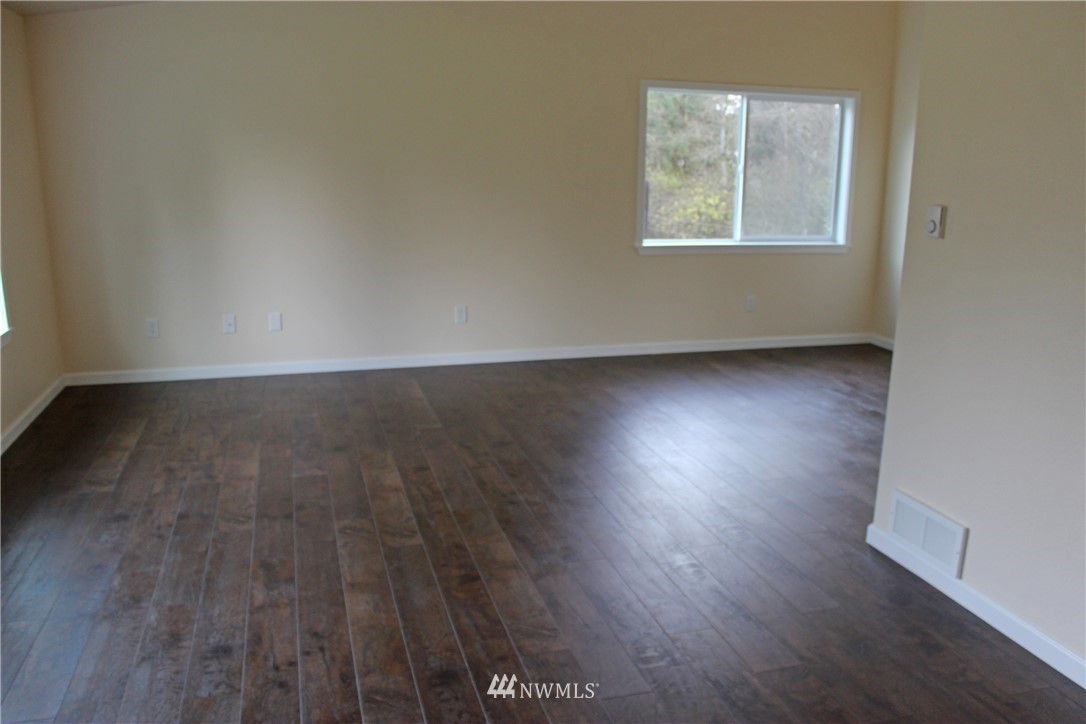 5425 Southwest 188th Avenue Southwest Rochester, WA 98579 - Photo 22 of 25 an empty room with wooden floor and windows