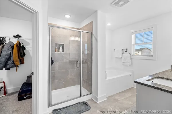 a bathroom with a tub and a shower