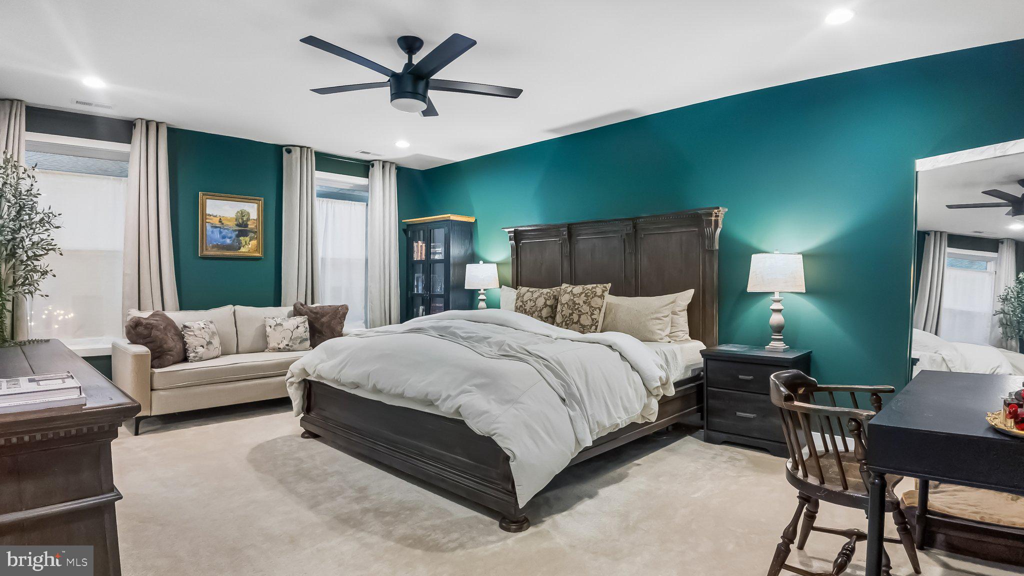 257 Junction Road Media, PA 19063 - Photo 12 of 25 a bedroom with a bed a couch and a potted plant