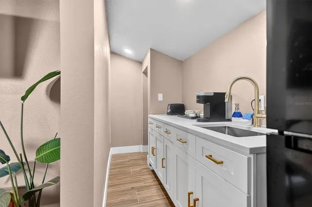 a kitchen with a sink and a refrigerator