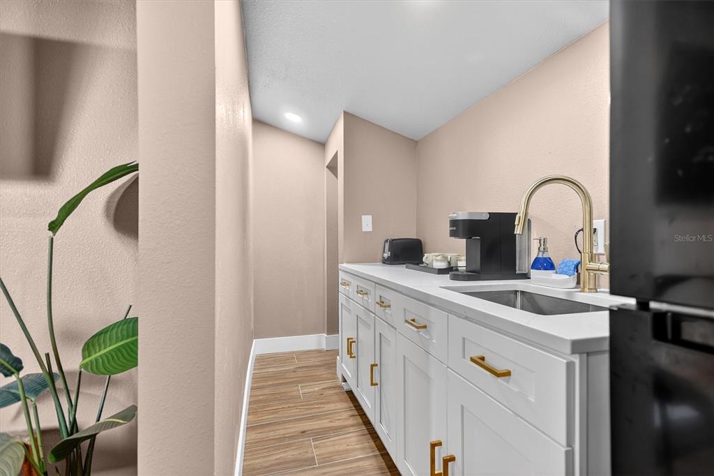 917 Mack Avenue, Unit 2 Orlando, FL 32805 - Photo 11 of 19 a kitchen with a sink and a refrigerator