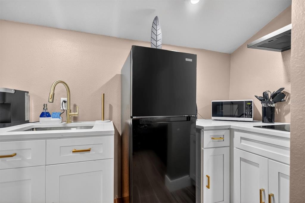 917 Mack Avenue, Unit 2 Orlando, FL 32805 - Photo 12 of 19 a kitchen with a refrigerator sink and cabinets