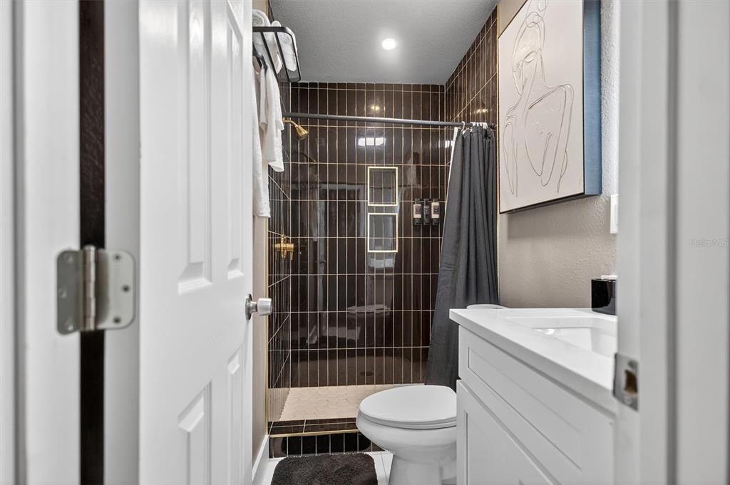 917 Mack Avenue, Unit 2 Orlando, FL 32805 - Photo 14 of 19 a bathroom with a toilet and a shower