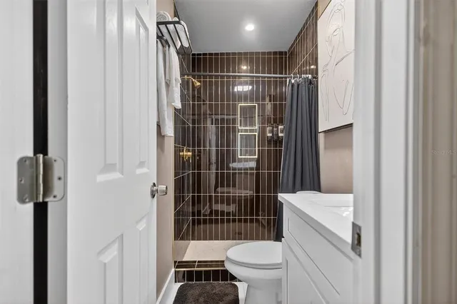 a bathroom with a sink toilet and shower