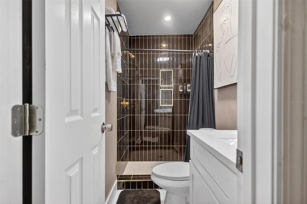 917 Mack Avenue, Unit 2 Orlando, FL 32805 - Photo 15 of 19 a bathroom with a toilet and a shower