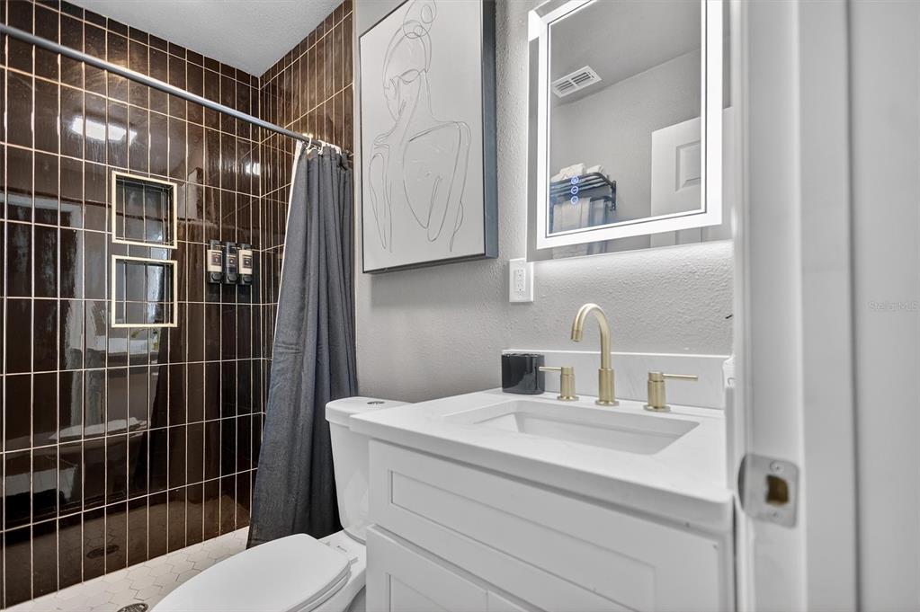 917 Mack Avenue, Unit 2 Orlando, FL 32805 - Photo 16 of 19 a bathroom with a sink toilet and shower