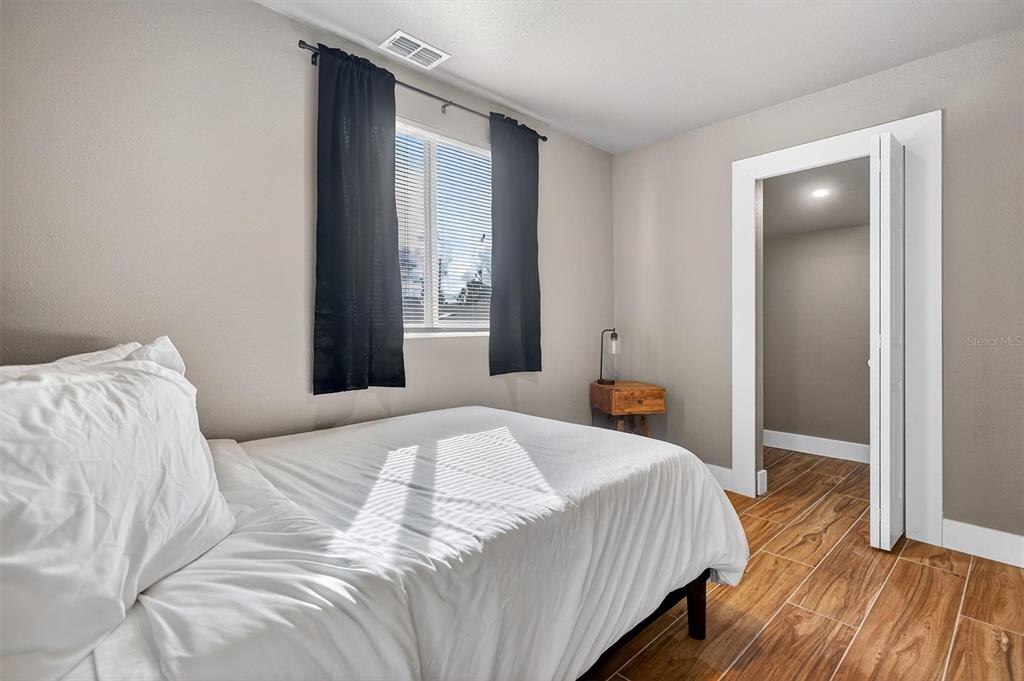 917 Mack Avenue, Unit 2 Orlando, FL 32805 - Photo 17 of 19 a bedroom with a bed and a window