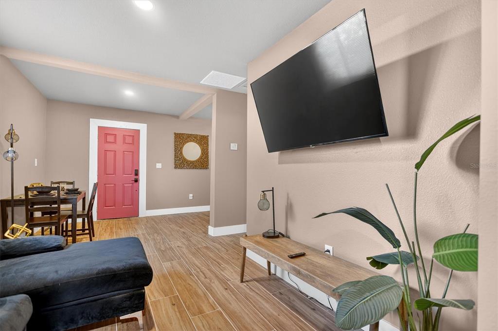 917 Mack Avenue, Unit 2 Orlando, FL 32805 - Photo 4 of 19 a living room with furniture and a flat screen tv