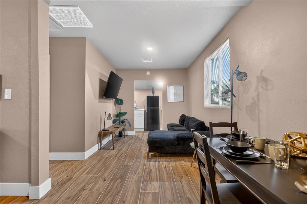 917 Mack Avenue, Unit 2 Orlando, FL 32805 - Photo 5 of 19 a view of a livingroom with furniture and a flat screen tv