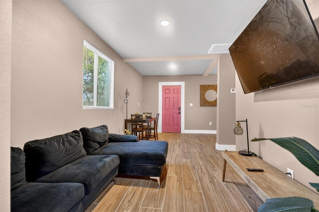 917 Mack Avenue, Unit 2 Orlando, FL 32805 - Photo 7 of 19 a living room with furniture and a flat screen tv