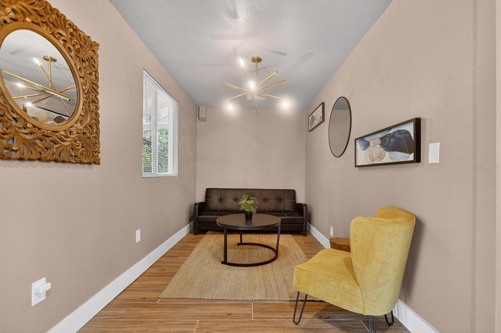 917 Mack Avenue, Unit 2 Orlando, FL 32805 - Photo 9 of 19 a room with furniture and a mirror