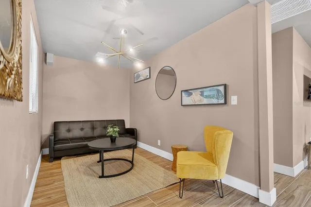 a living room with furniture and a chandelier