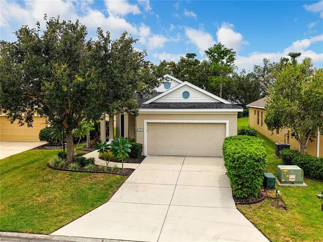 an aerial view of a house with a yard