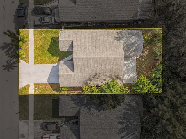 an aerial view of a residential houses with outdoor space