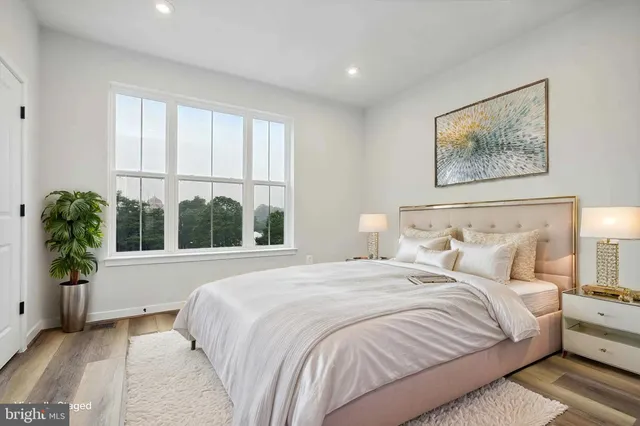 a bedroom with a large bed and a large window
