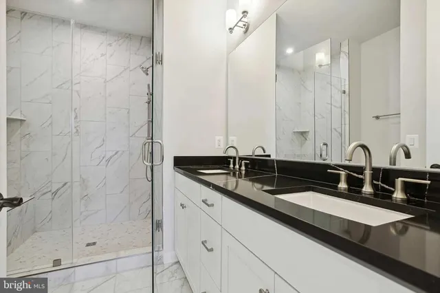 a bathroom with double sink and a mirror
