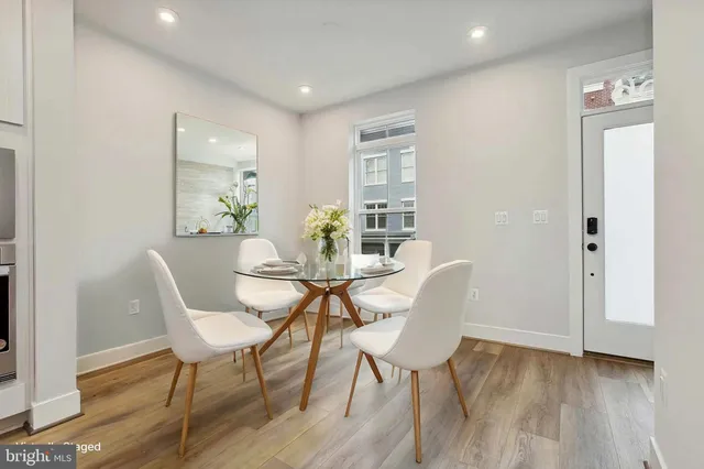 a dining room with furniture and wooden floor