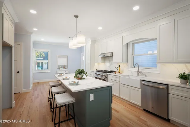 a kitchen with kitchen island a sink stove and refrigerator