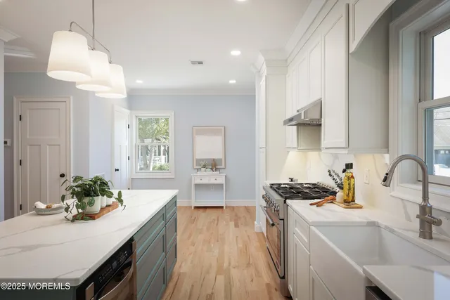 a kitchen with a table chairs stove and cabinets