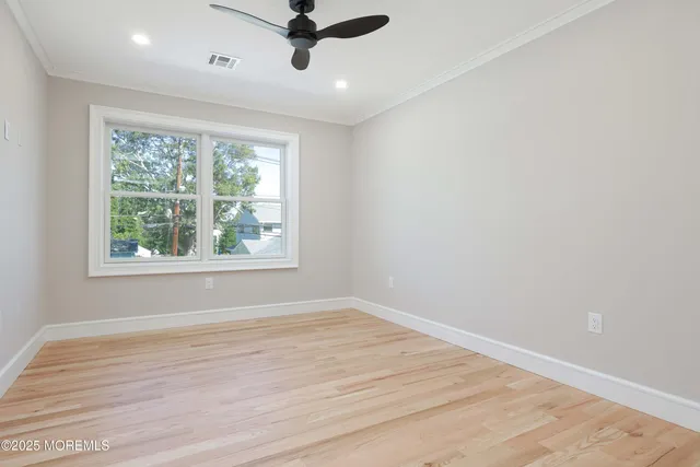 a view of a room with wooden floor and windows
