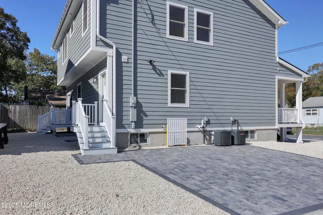 a view of backyard with a table and chair and wooden fence