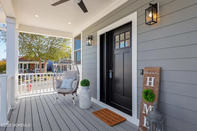 a view of living room and porch with wooden floor