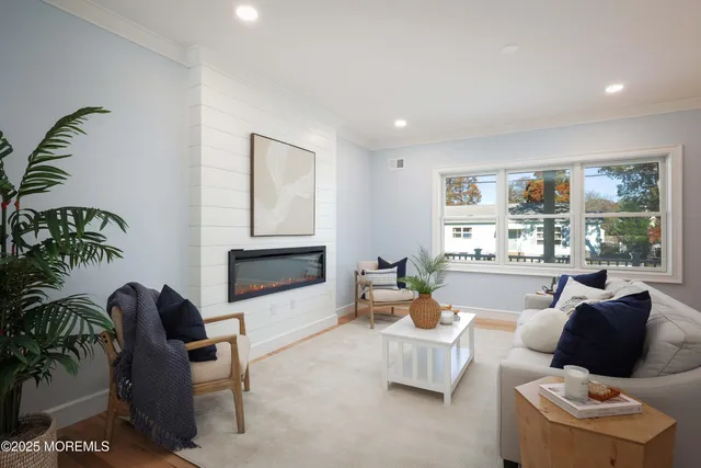 a living room with stainless steel appliances kitchen island granite countertop furniture and wooden floor