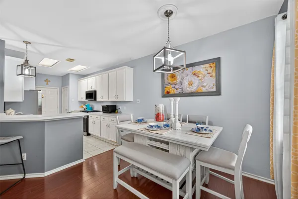 a kitchen with white cabinets and appliances