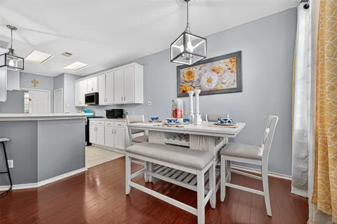 a kitchen with white cabinets appliances and a sink