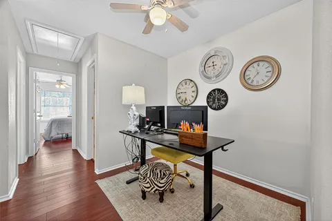 a large bed sitting in a bedroom next to a window and a chandelier