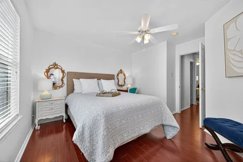 a bedroom with bed and wooden floor
