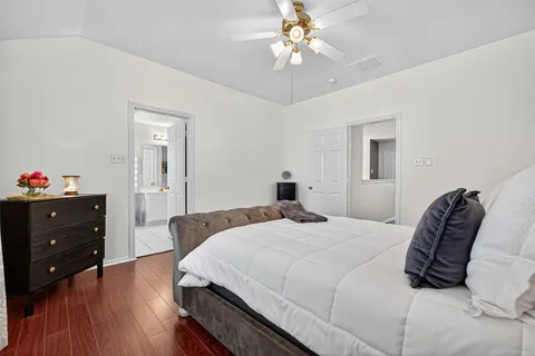 a bedroom with a bed and a chandelier