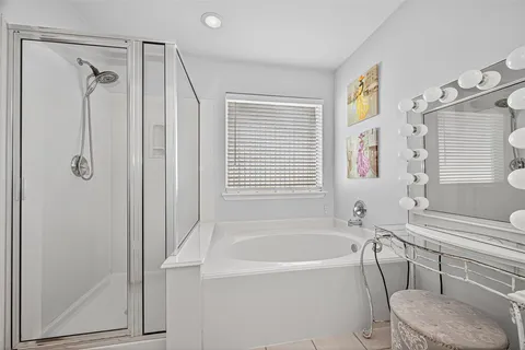 a bathroom with a bathtub and a shower