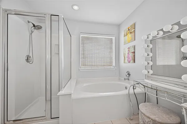 a bathroom with a bathtub and a shower