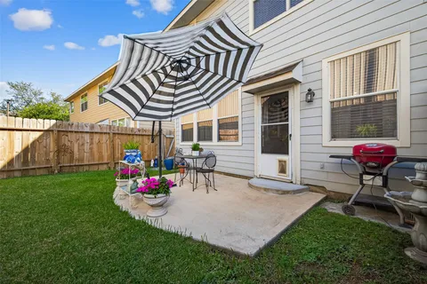 a view of a patio with table and chairs and potted plants