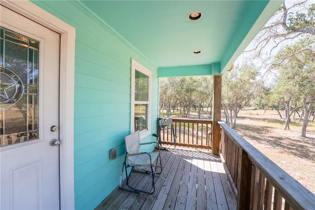 a view of a porch with furniture and wooden floor
