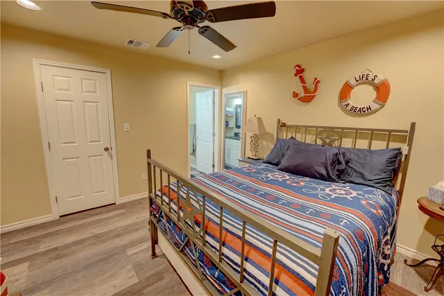 a bedroom with bed and wooden floor