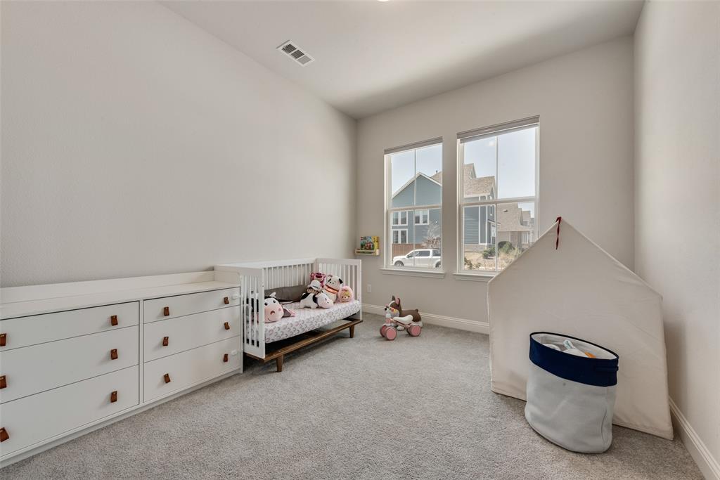 8922 Edna Place Rowlett, TX 75089 - Photo 20 of 37 Bedroom featuring visible vents, a crib, baseboards, and carpet