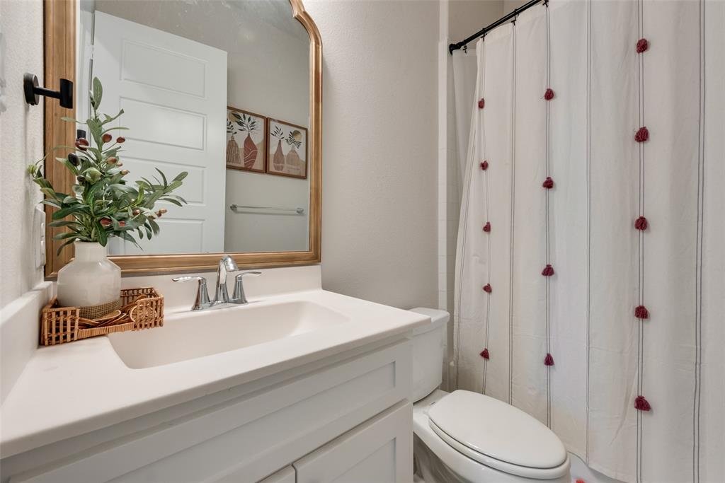8922 Edna Place Rowlett, TX 75089 - Photo 21 of 37 Bathroom featuring a shower with curtain, toilet, and vanity