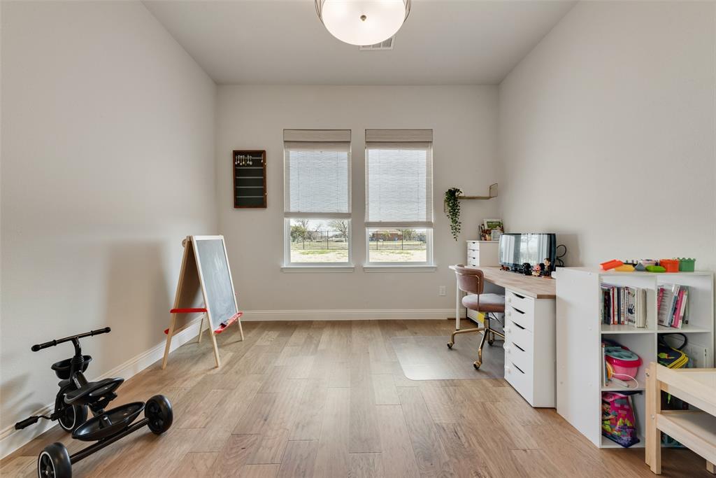 8922 Edna Place Rowlett, TX 75089 - Photo 26 of 37 Home office featuring visible vents, light wood-style flooring, and baseboards