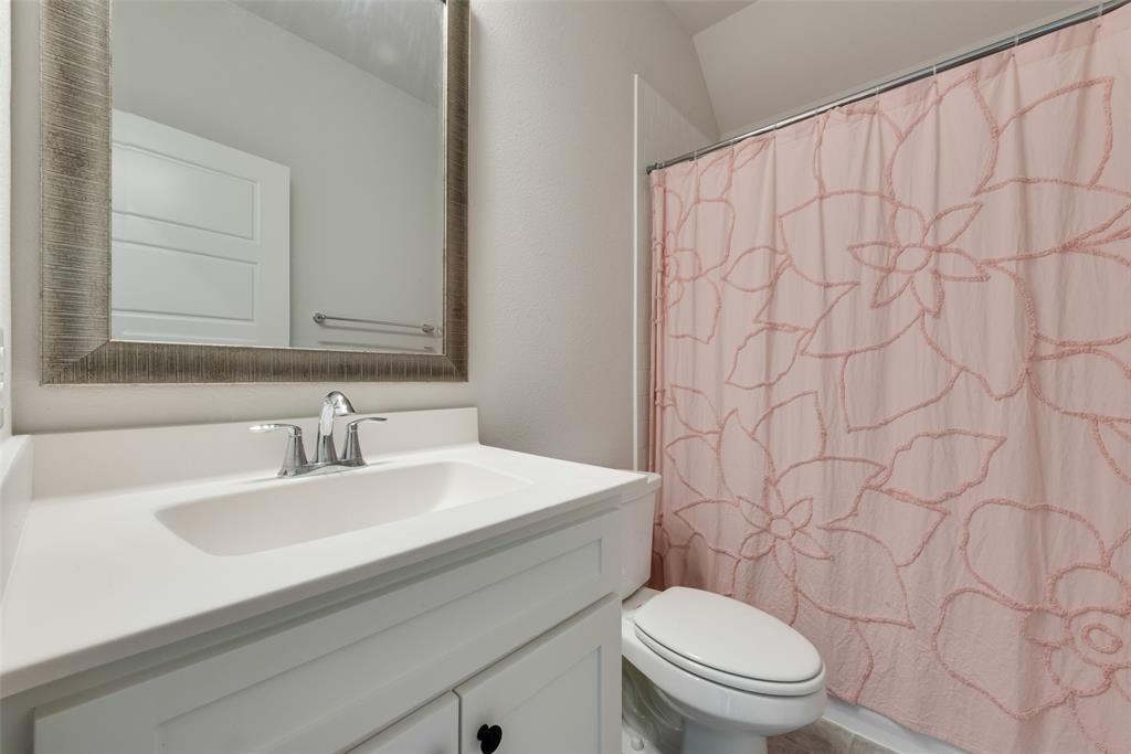 8922 Edna Place Rowlett, TX 75089 - Photo 27 of 37 Bathroom with toilet, curtained shower, and vanity