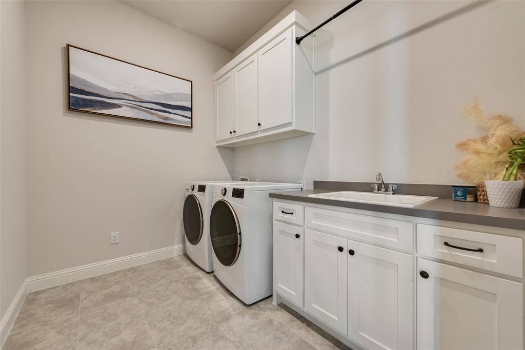 8922 Edna Place Rowlett, TX 75089 - Photo 34 of 37 Clothes washing area with baseboards, cabinet space, independent washer and dryer, and a sink
