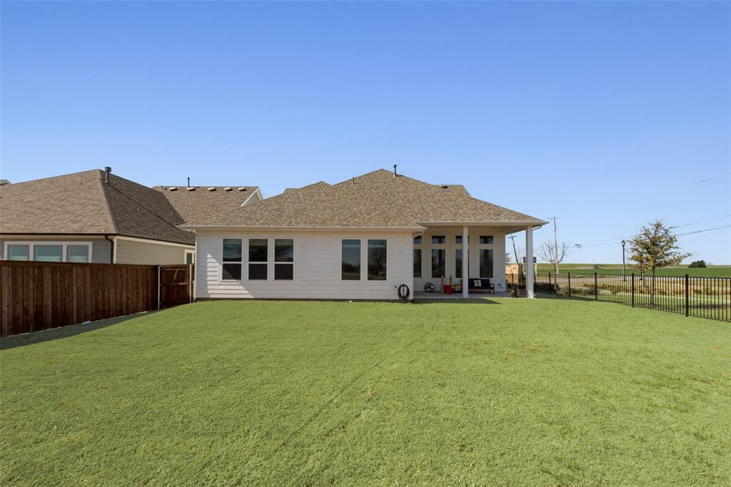 8922 Edna Place Rowlett, TX 75089 - Photo 36 of 37 Rear view of house featuring a patio area, a lawn, a fenced backyard, and roof with shingles