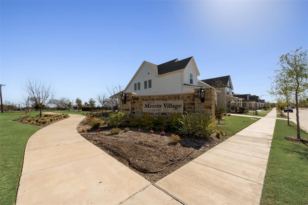 8922 Edna Place Rowlett, TX 75089 - Photo 4 of 37 View of property exterior featuring a yard and stone siding