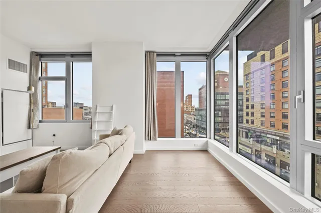 a living room with furniture and a large window with outer view