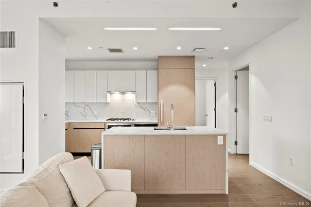 a kitchen with stainless steel appliances granite countertop a stove a sink and a refrigerator